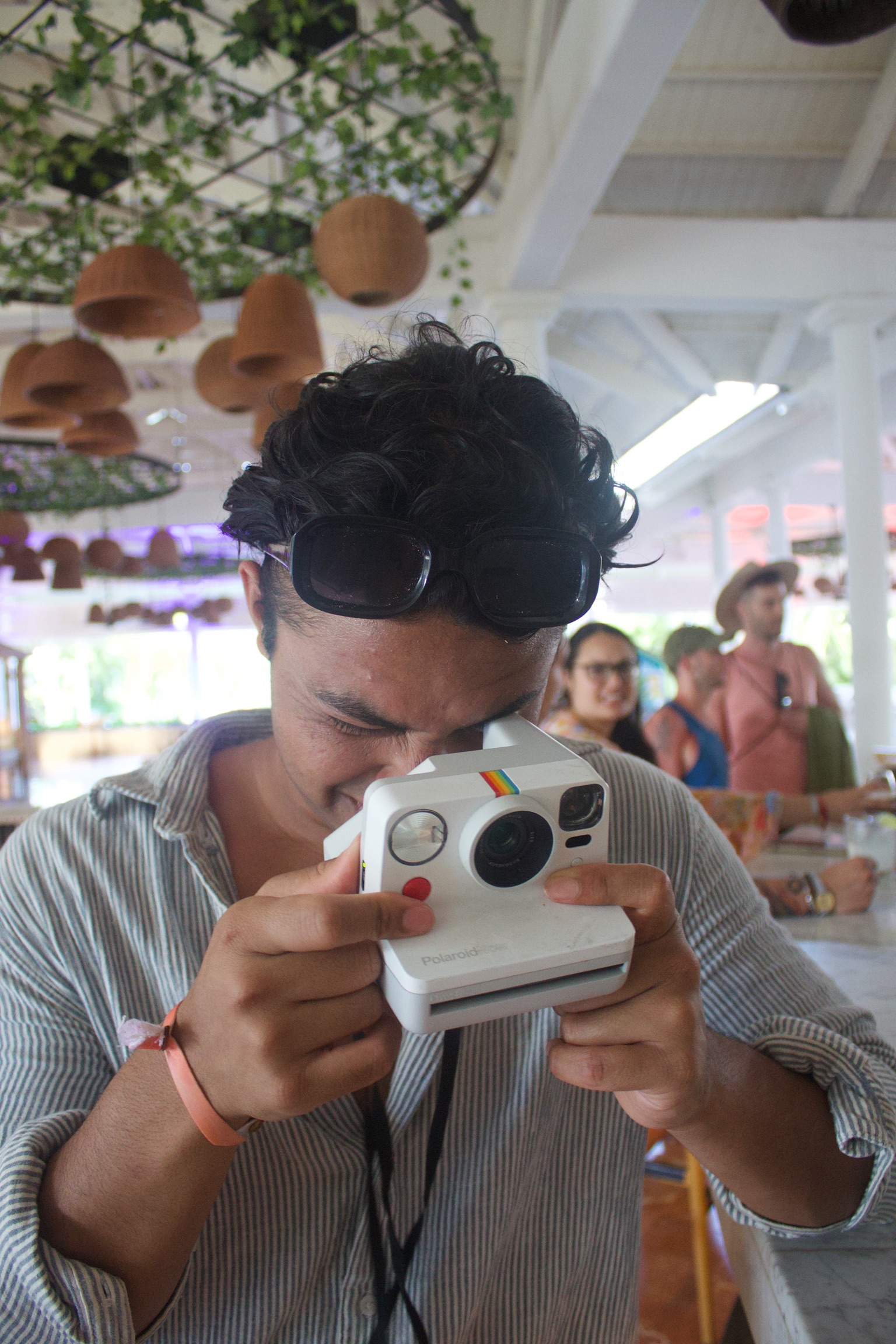 Farabi holding a Polaroid camera